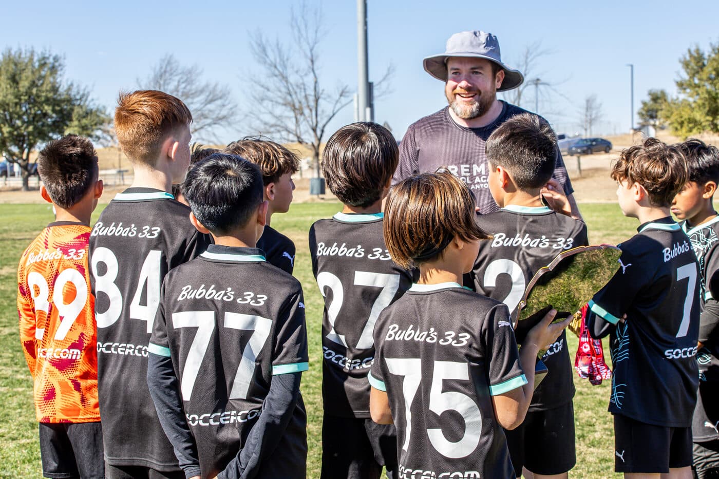 Premier FA coach with players